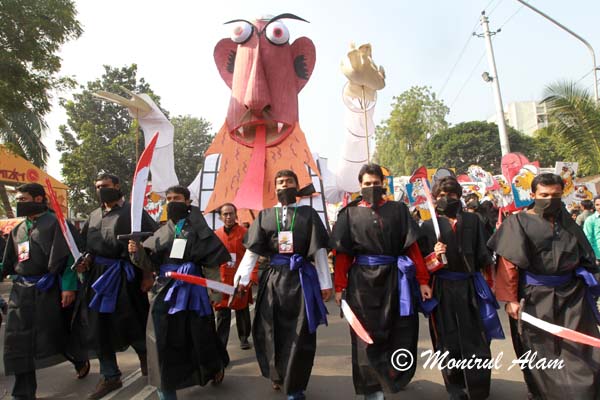 DEC 16 2012-Dhaka, Bangladesh- Bangladeshis carry caricatures of war criminals and them holdup fake bloody shards during a rally on Sunday 16 December. They attend a rally to celebrate the 41st victory day in Dhaka, on Sunday 16 December. Bangladesh became an independent nation on 16 December 1971 after a nine month-long armed conflict with Pakistan. © Monirul Alam   