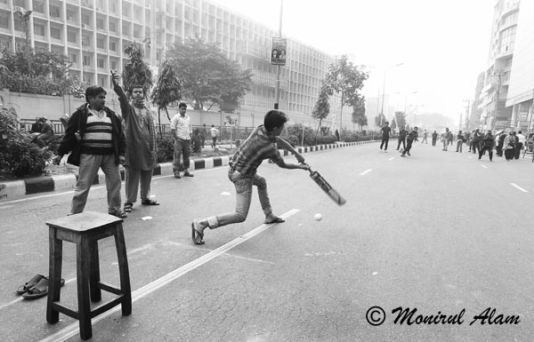 DEC 18 2012-Dhaka, Bangladesh- Communist Party of Bangladesh ( CPB) activists plays cricket on the street  during a nationwide strike in Dhaka on Tuesday. The daylong strike called by the Communist Party of Bangladesh (CPB) and Bangladesh Shamajtantrik Dal (BSD), demanding a ban on all communal political parties including Jamaat-e-Islami. © Monirul Alam