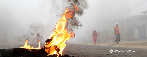 DEC 09 2012-Dhak, Bangladesh- BNP activities set fire on the tire  on the road of Keranigonj outskates of Dhaka during the road blocked of BNP on Sunday. The BNP led opposition alliance is observing eight hours countrywide road blocked. They are demanding restoration of the caretaker government system. © Monirul Alam  