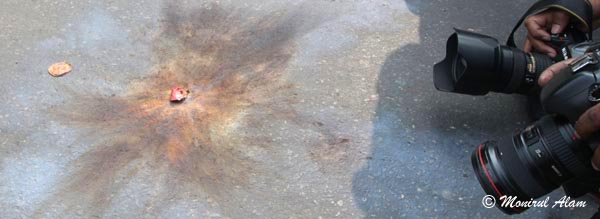 DEC 09 2012-Dhak, Bangladesh- Photojournalists take picture after exploded cocktails in front of BNP office during the road blocked of BNP on Sunday. The BNP led opposition alliance is observing eight hours countrywide road blocked. They are demanding restoration of the caretaker government system. © Monirul Alam