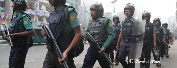 DEC 10 2012-Dhak, Bangladesh- Police patrols in front of BNP Nayapalton office on Monday. The activists of BNP and its close ally Jamaat-e-Islami set fire to at least nine buses and vandalized many others in the capital on the eve of Tuesday's dawn-to-dusk nationwide strike. They are demanding restoration of the caretaker government system. © Monirul Alam