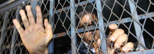 DEC 11 2012-Dhak, Bangladesh- BNP acting secretary general Mirza Fakrul Islam Alamgir show his hand form the prison van on Tuesday, he sent to jail after being denied bail in two cases filed with Sher-e-Bangla Nagar and Paltan police stations. BNP and its close ally Jamaat-e-Islami observed dawn-to-dusk nationwide strike on Tuesday. They are demanding restoration of the caretaker government system. © Monirul Alam