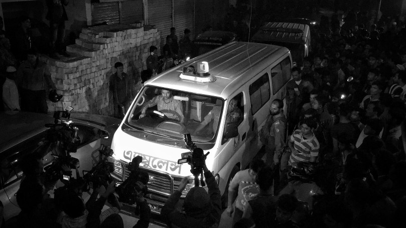 December 24, 2016 - Dhaka, Bangladesh - Police ambulance carry a suspected Islamist dead body to the Dhaka Medical Hospital after and operation to storm an alleged militant hideout in Dhaka on December 24, 2016, as a team from the counterterrorism unit of Dhaka Metropolitan Police cordoned off a three-storey building in the capital. Two female militants along with two children surrendered to the cops, 1 female and a teen militant killed themselves during police raid by exploding suicidal vest outside their den while acting to surrender to the cops. © Monirul Alam 